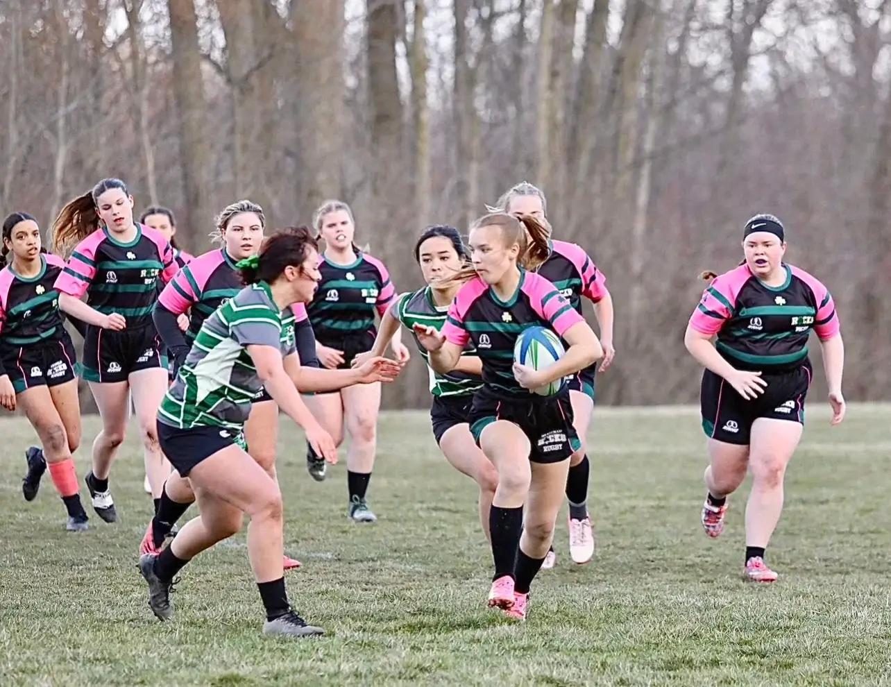 Junior Emily Doll carrying the ball and high school girls (1)